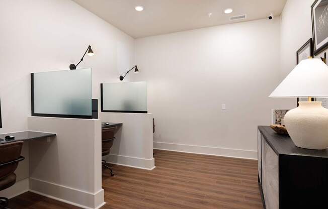 A room with a desk and two chairs.