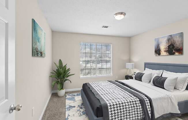 a bedroom with a bed and a potted plant