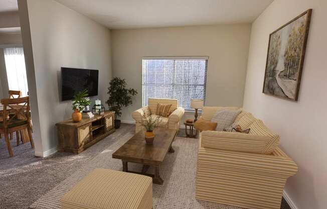 Liberty Landing Apartments in West Jordan Utah living room in Midway floor plan with couch, coffee table and television.
