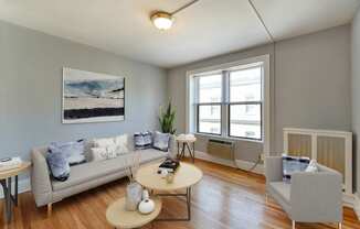 living area with sofa, coffee table , hardwood floors and large windows at the shawmut in washington dc