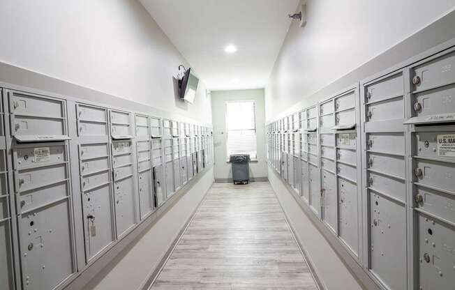 A long hallway with a series of lockers on the wall.