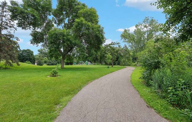 A pathway surrounded by greenery and trees.