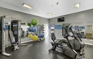 a gym with cardio equipment and weights  at Camelot Apartment Homes, Everett, WA, 98204