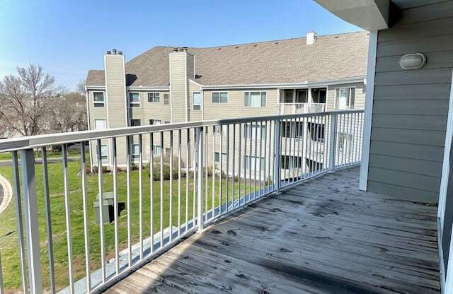 a view of a house from a balcony with a wooden deck