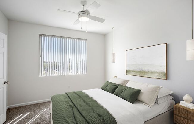 a bedroom with a bed and a ceiling fan