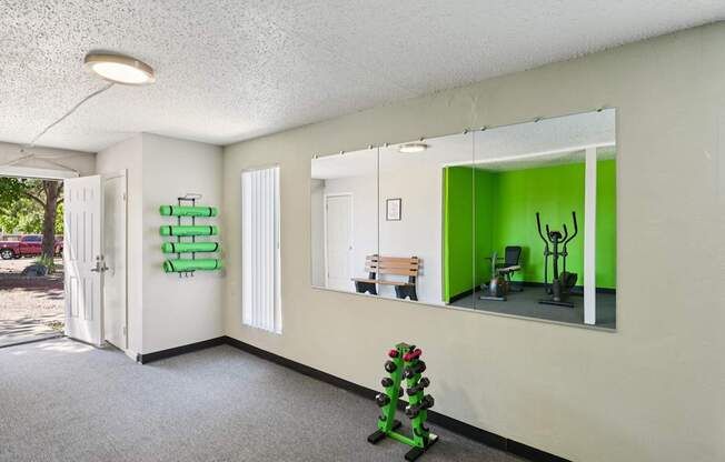 A room with a green wall and a mirror.