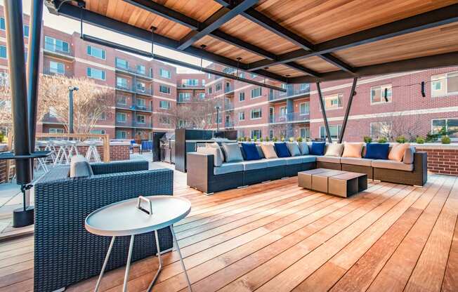 a rooftop patio with furniture and a table