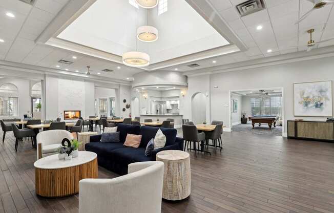 A spacious living room with a variety of seating options and a fireplace.