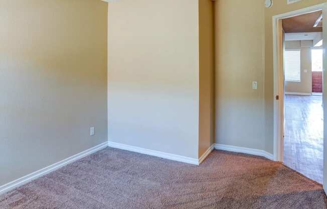 a living room with a carpeted floor and a white wall