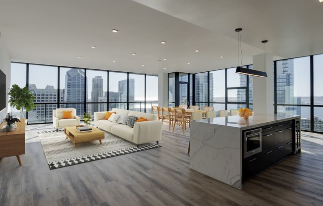 a living room with a kitchen and a city view