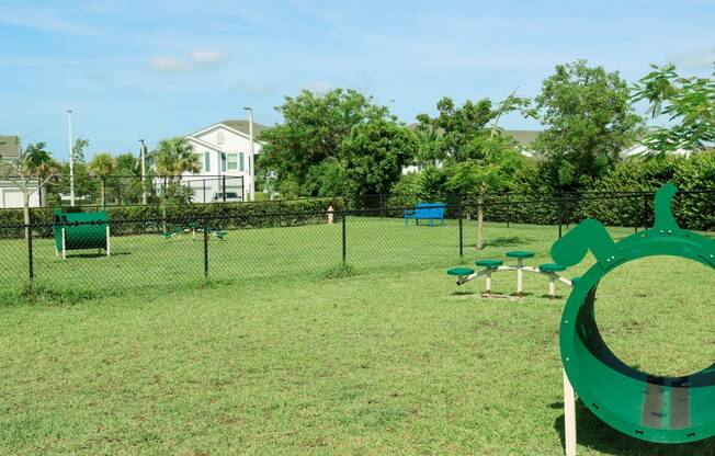 a park with a playground and a swing set