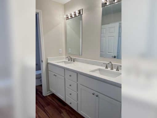 a bathroom with two sinks and a large mirror