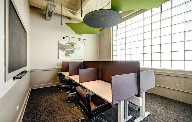 a conference room with a table and chairs and a large window