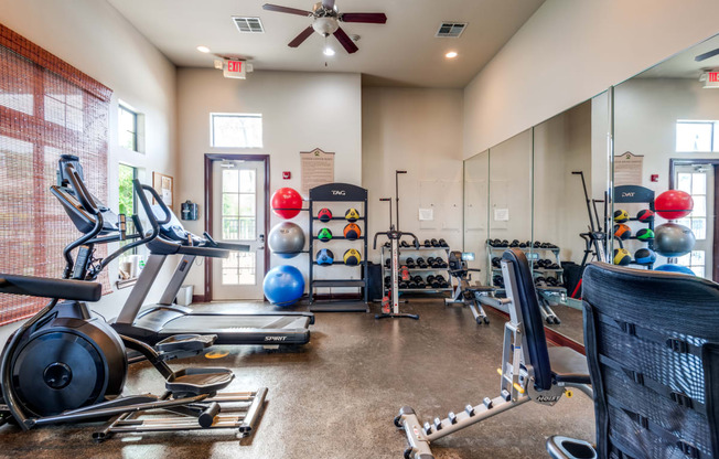 the gym with cardio equipment at the belgard apartments mn