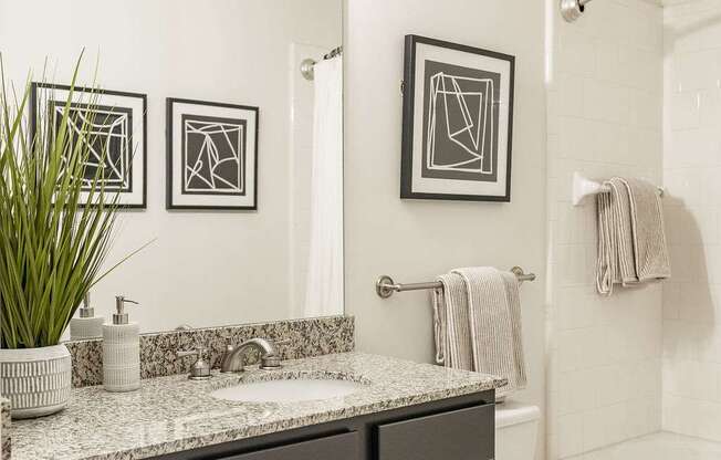 A bathroom with a white toilet and a sink with a counter top.