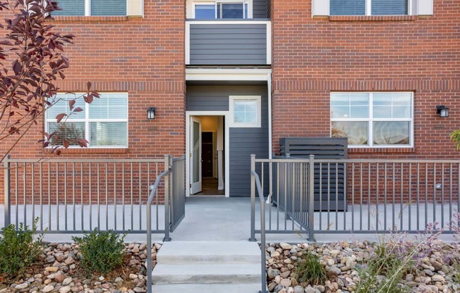 red brick stone building and patio at Palisade Park Townhomes, Broomfield, 80023