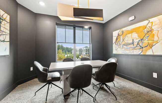 A conference room with a large table and chairs.