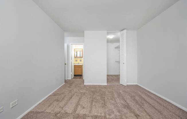 bedroom with attached walk-in closet and full bathroom