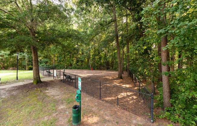 a park with a fenced in area and trees