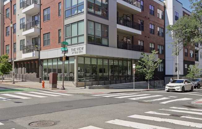 A street view of a building named "The View" at an intersection.