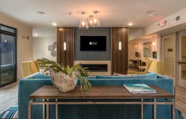 A living room with a blue couch and a wooden coffee table.