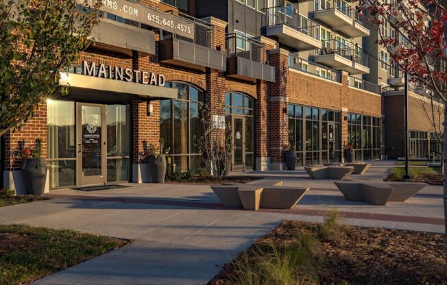 an entrance to a building with benches in front of it