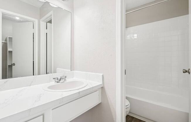B6 white bathroom with a sink and a mirror.