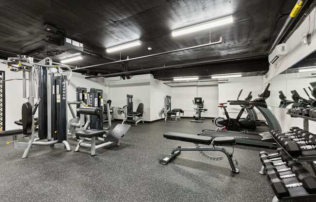 a gym with weights and other equipment in a building with black ceilings at Rialto, Washington, 20002