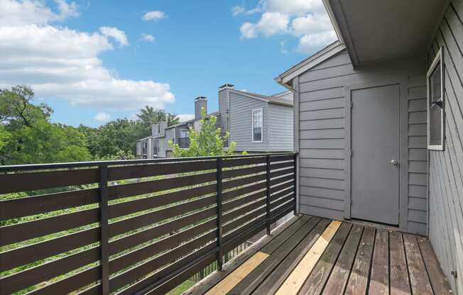 the deck of a home with a door to the backyard