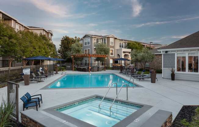 Apartments in Napa for Rent - Montrachet - Resort-Style Pool Area with Jacuzzi, Lounge Chairs, and Umbrellas