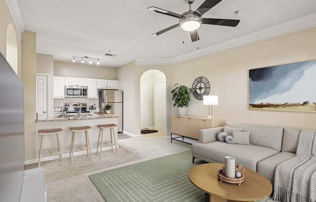 A living room with a grey couch and a wooden coffee table.
