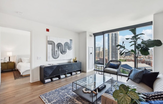 a living room with a large window and a couch and a table at Cassidy on Canal, Chicago, IL, 60654