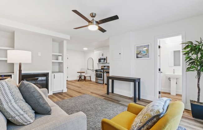 a living room with a couch and a ceiling fan