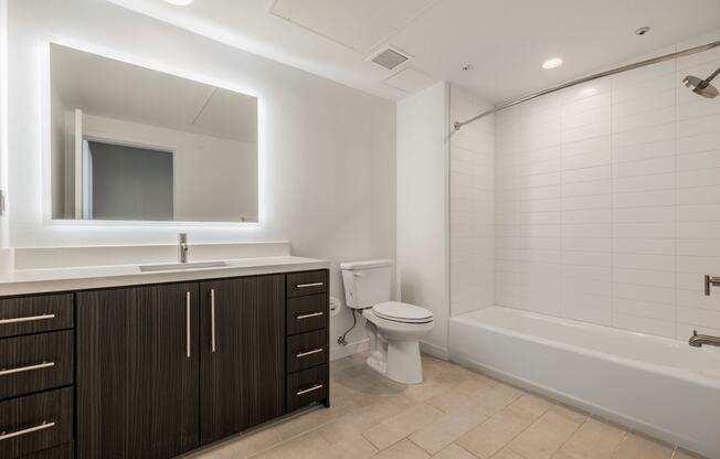 a bathroom with a toilet and a sink and a bath tub