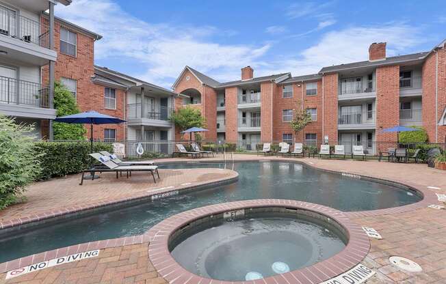 A pool with a sign that says "No Diving" in front of a brick building.