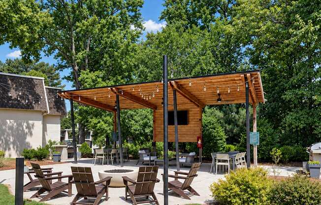 Picnic tables beneath a wooden pergola at Icon Avondale Apartments in Decatur, GA.