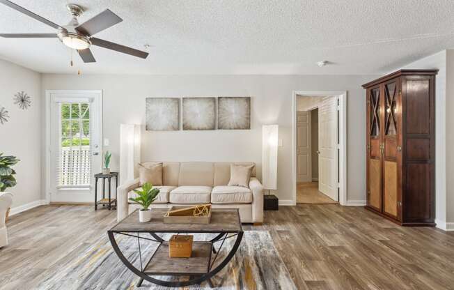 a living room with a couch and a ceiling fan