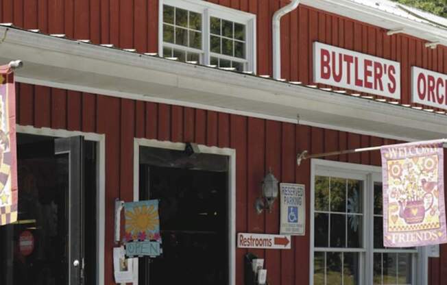 A red building with a sign that says Butler's Orchard.