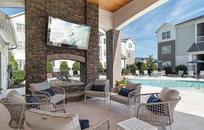 A patio with a fireplace and chairs is shown.