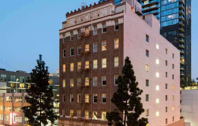 a view of a tall building and a city street at night