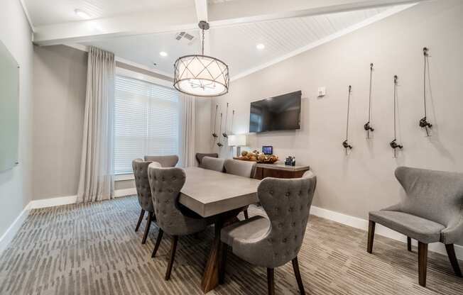 a dining room with a table and chairs and a tv
