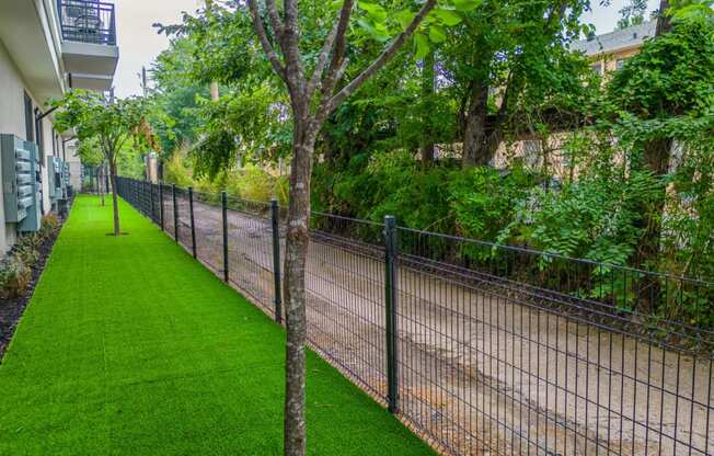 a chain link fence with a grassy area next to it