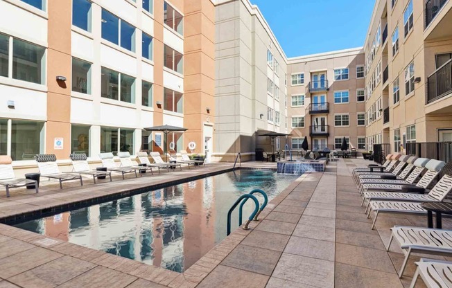 a swimming pool in the middle of some buildings