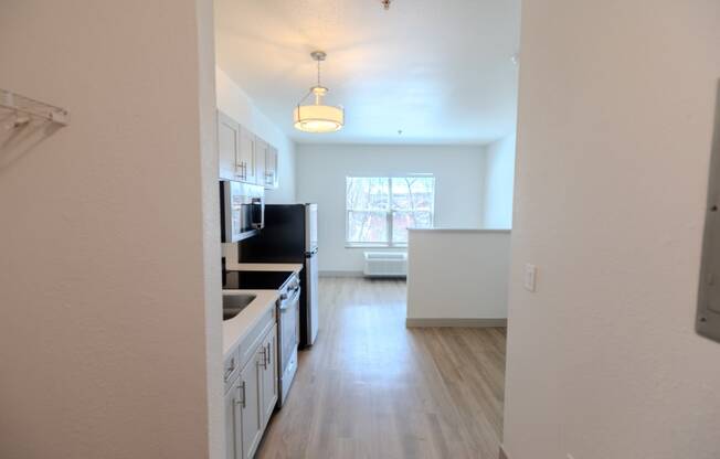 a kitchen and living room in an empty apartment