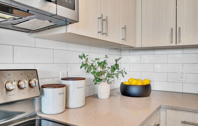 a kitchen counter with a bowl of fruit on it