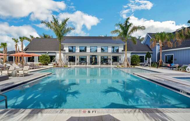 a large swimming pool in front of a building  at The Sophia, Venice, FL, 34275