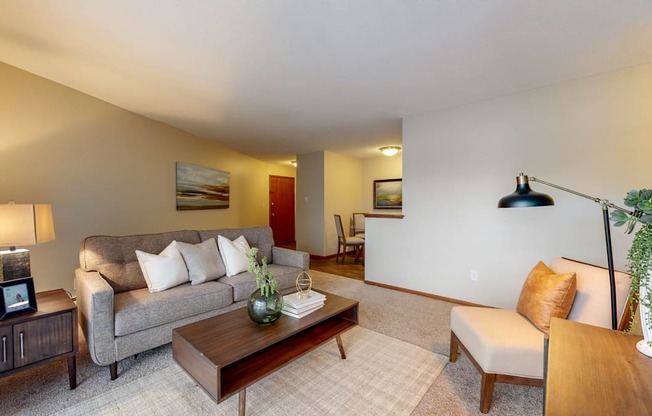 a living room with a gray couch and a wooden coffee table