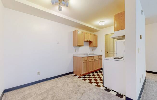 a kitchen with a white refrigerator freezer next to a stove top oven