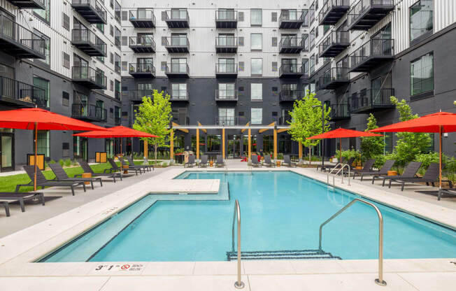 a swimming pool in front of an apartment building