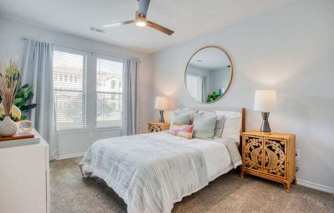 a bedroom with a bed and a mirror  at Edge and Stone, San Antonio